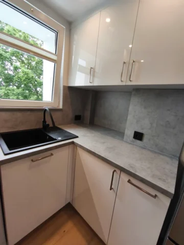 meble z frontami na wysoki polysk białe oraz beton jasno szary